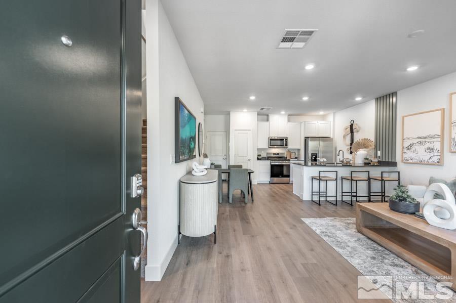 1605 Switchback Street, Unit LOT #29 Reno, NV 89523 - Photo 2 of 20 a open kitchen with white cabinets and stainless steel appliances