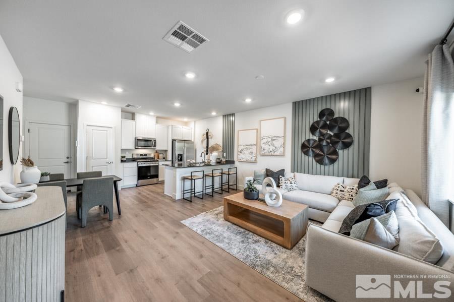 1605 Switchback Street, Unit LOT #29 Reno, NV 89523 - Photo 3 of 20 a living room with furniture kitchen view and a wooden floor