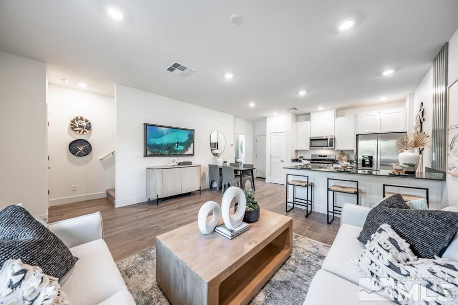 1605 Switchback Street, Unit LOT #29 Reno, NV 89523 - Photo 5 of 20 a living room with furniture kitchen view and a flat screen tv