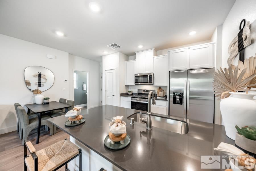 1605 Switchback Street, Unit LOT #29 Reno, NV 89523 - Photo 7 of 20 a kitchen with refrigerator and wooden floor
