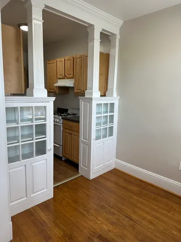a view of kitchen with wooden floor and electronic appliances