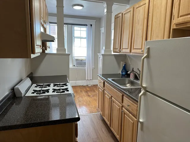 a kitchen with granite countertop a stove and a sink