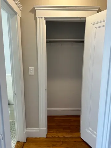 a view of closet area with wooden floor