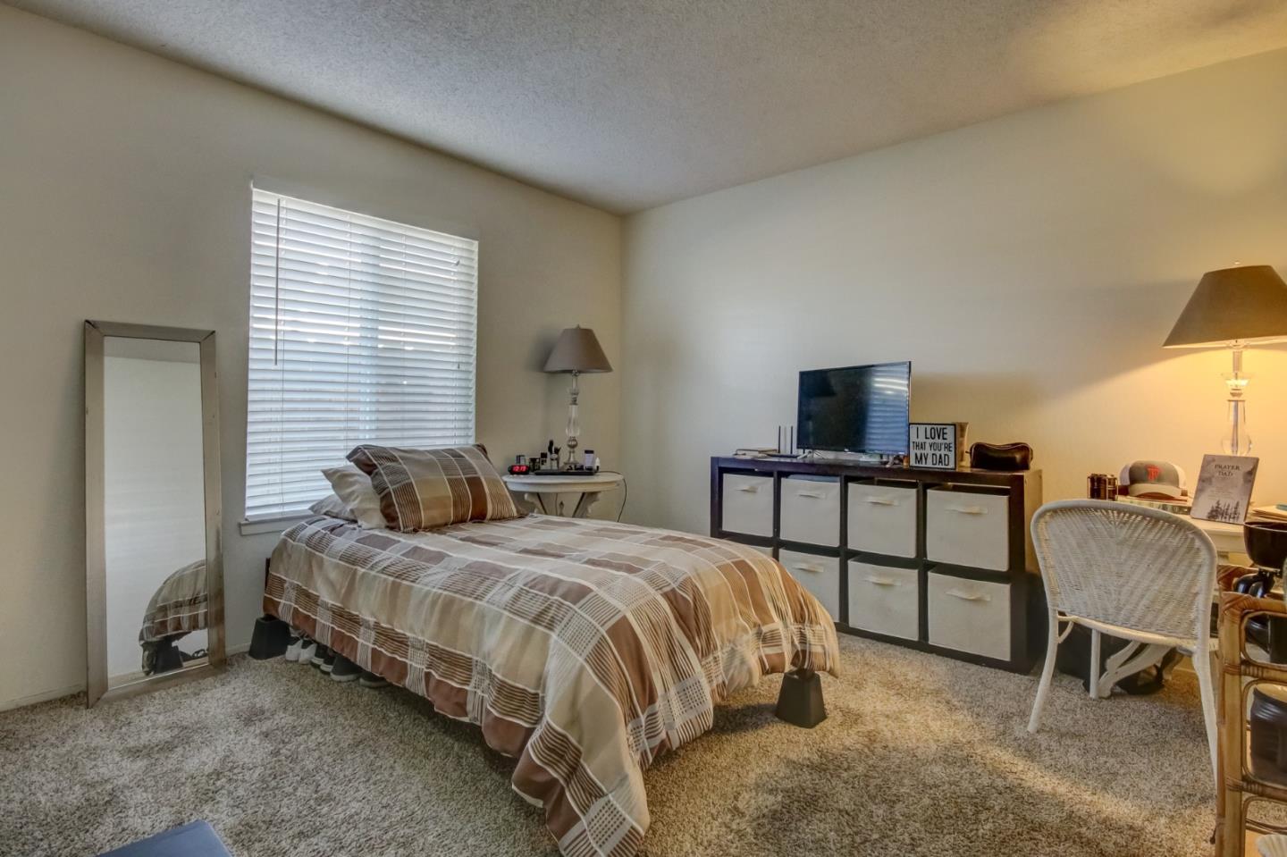 1759 Emerald Drive Salinas, CA 93906 - Photo 13 of 21 a bedroom with a bed and a table in it
