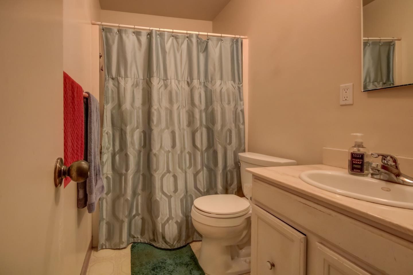 1759 Emerald Drive Salinas, CA 93906 - Photo 15 of 21 a bathroom with a sink a toilet and shower curtain