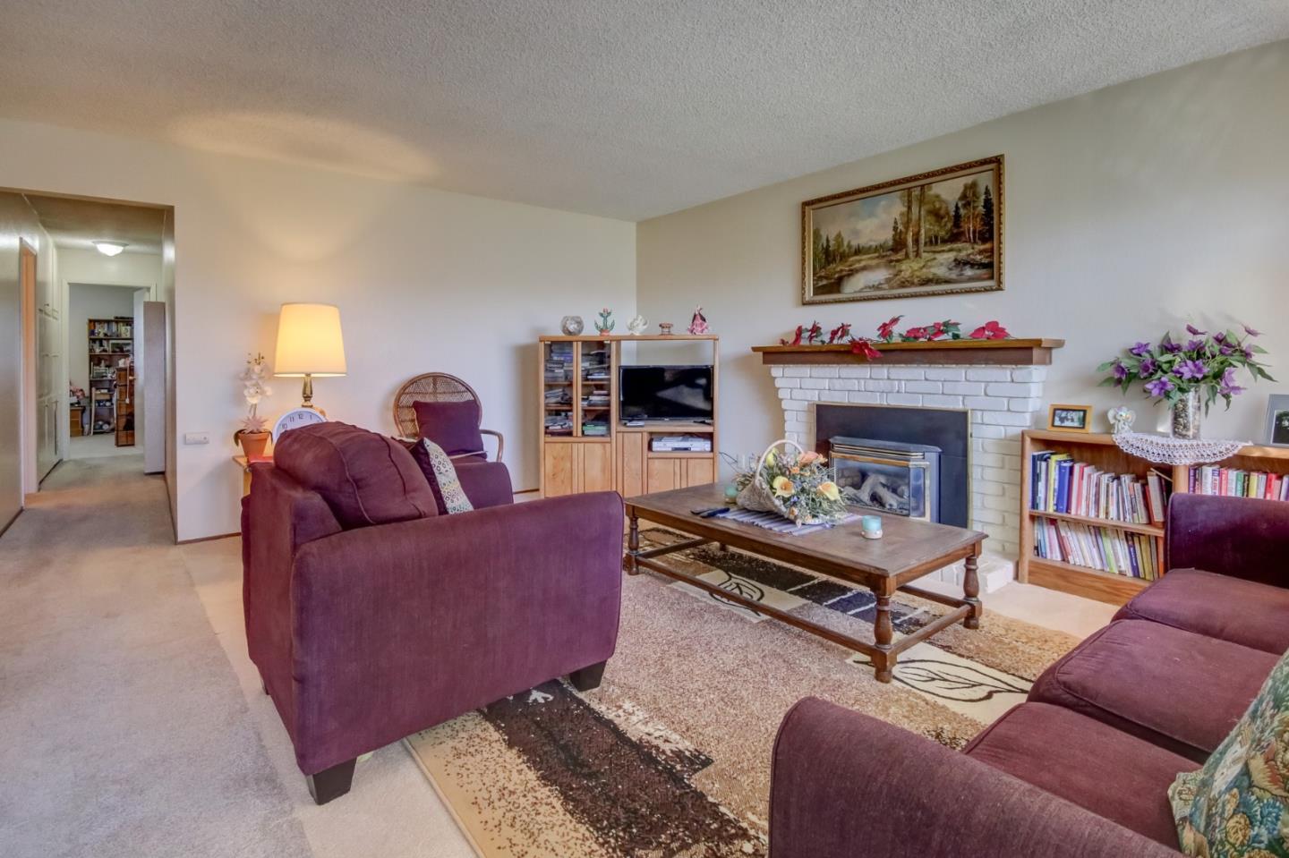 1759 Emerald Drive Salinas, CA 93906 - Photo 5 of 21 a living room with furniture a flat screen tv and a fireplace