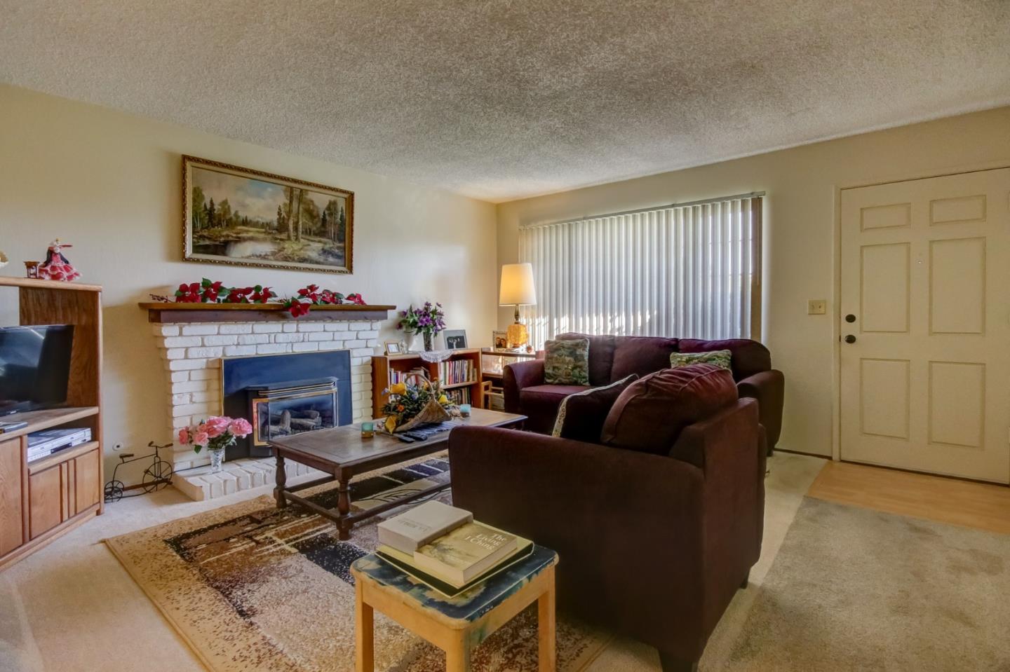 1759 Emerald Drive Salinas, CA 93906 - Photo 7 of 21 a living room with furniture a flat screen tv and a fireplace