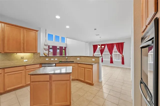 a kitchen with stainless steel appliances granite countertop a sink and cabinets