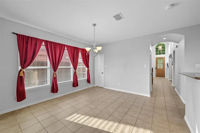 a living room with furniture a fireplace and a potted plant