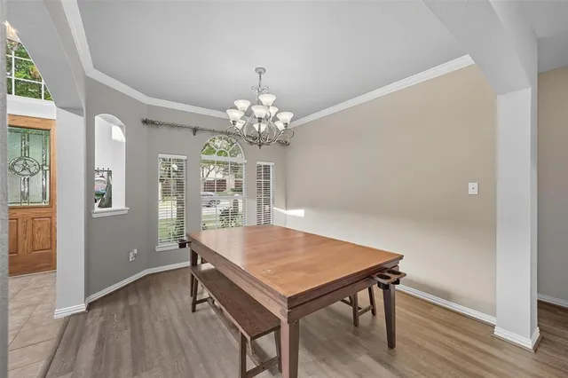 a view of a dining room with furniture and chandelier