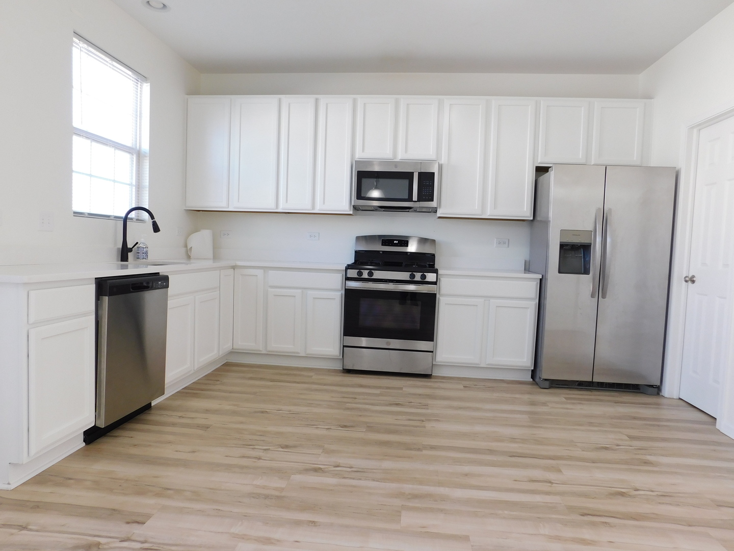 3748 Bailey Road, Unit 3748 Yorkville, IL 60560 - Photo 8 of 27 a kitchen with stainless steel appliances a refrigerator stove and sink