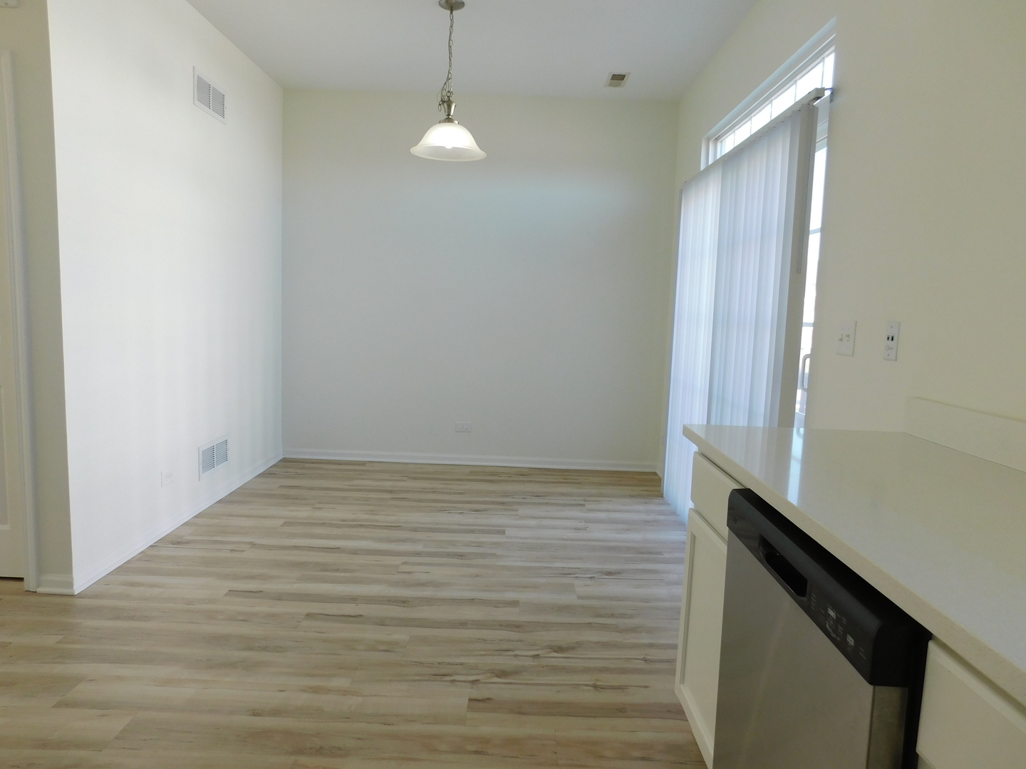 3748 Bailey Road, Unit 3748 Yorkville, IL 60560 - Photo 9 of 27 a view of an empty room with wooden floor and a window
