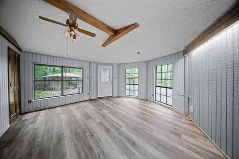 a kitchen with a refrigerator a stove a washer dryer and wooden floor