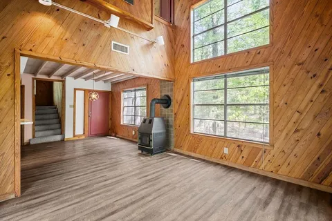 a view of a room with wooden floor and furniture
