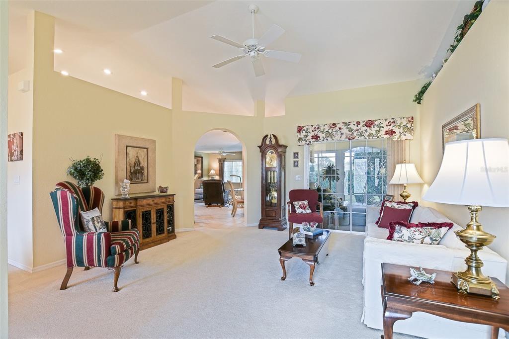 8850 Southeast 140th Place Road Summerfield, FL 34491 - Photo 30 of 98 a living room with furniture a chandelier and a fireplace