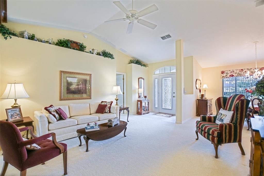 8850 Southeast 140th Place Road Summerfield, FL 34491 - Photo 32 of 98 a living room with furniture and a chandelier