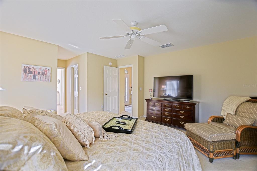 8850 Southeast 140th Place Road Summerfield, FL 34491 - Photo 38 of 98 a bedroom with a bed and a flat screen tv