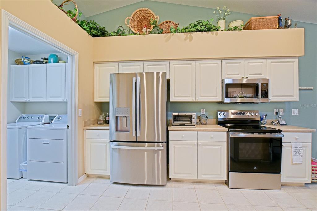 8850 Southeast 140th Place Road Summerfield, FL 34491 - Photo 48 of 98 a kitchen with cabinets stainless steel appliances and a counter space