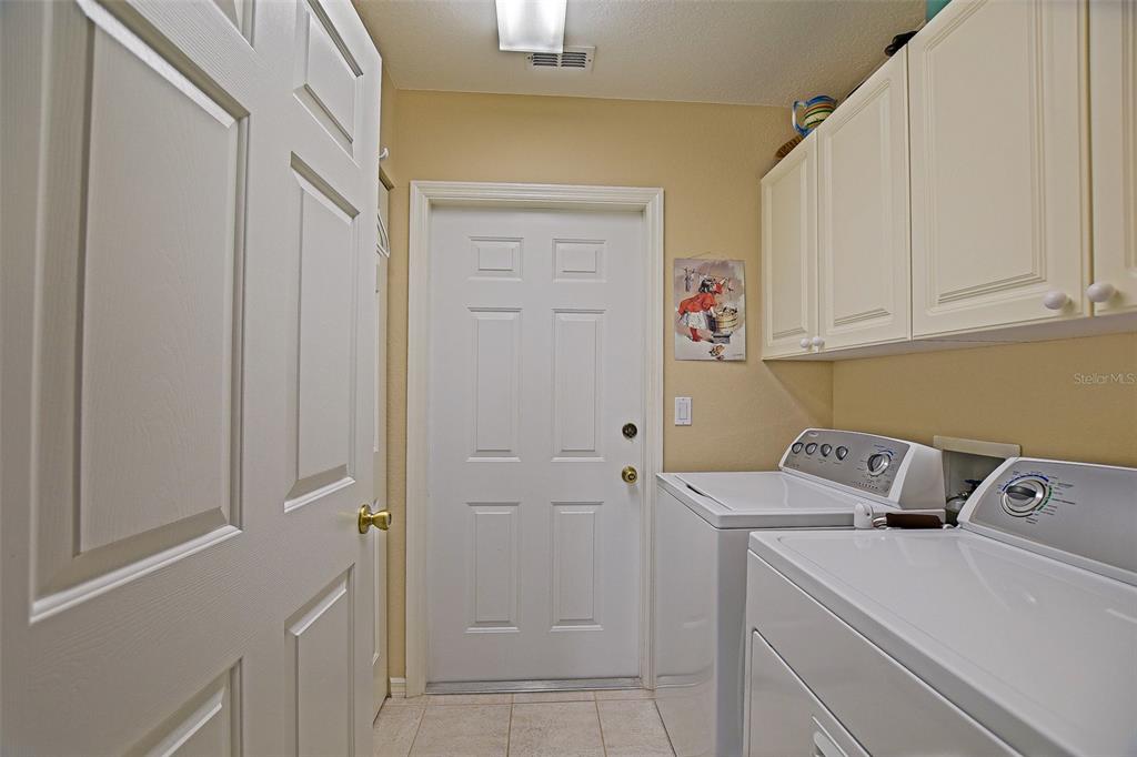 8850 Southeast 140th Place Road Summerfield, FL 34491 - Photo 66 of 98 a view of storage and utility room with washer and dryer