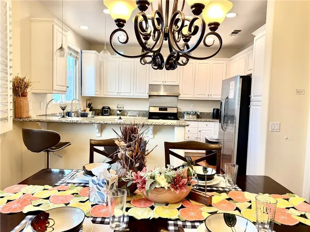 a kitchen with stainless steel appliances kitchen island granite countertop a sink and cabinets