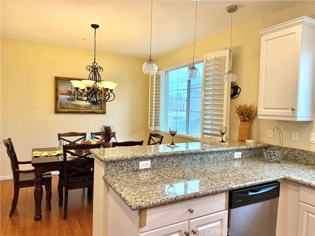 a kitchen with granite countertop a sink a counter top space and cabinets