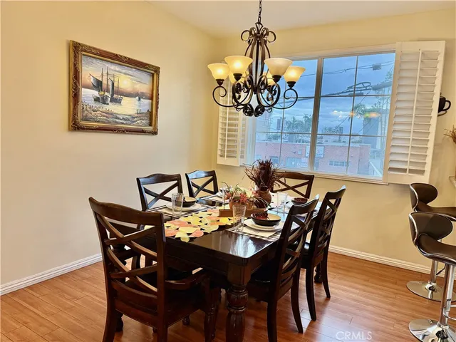 a view of a dining room with furniture wooden floor and chandelier