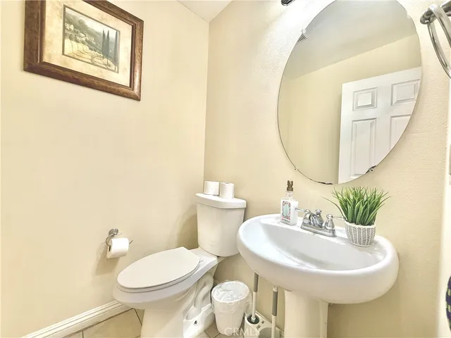 a bathroom with a toilet a sink and a mirror