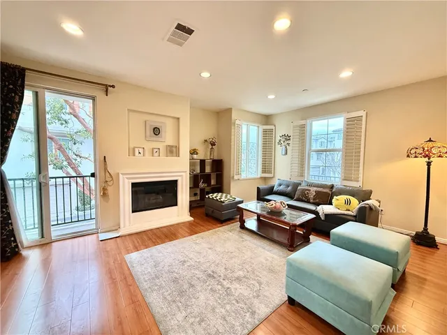 a living room with furniture a window and a fireplace