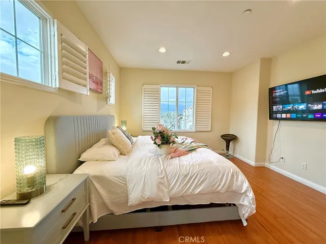 a bedroom with a bed and wooden floor
