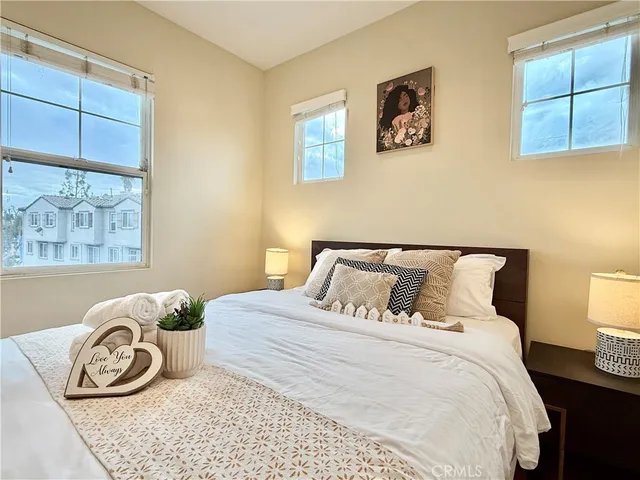 a bedroom with a bed and a window