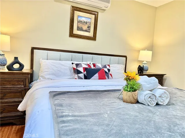 a bed sitting in a bedroom next to a lamp