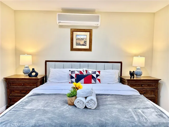 a bedroom with a bed and lamp