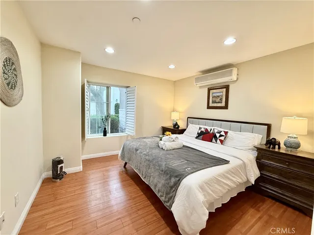 a bedroom with bed and a large window