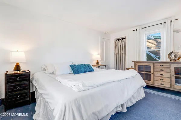 a bedroom with bed and a window