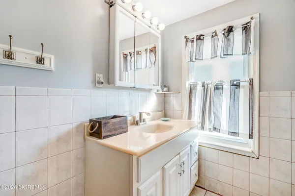 a view of a house with a yard and potted plants