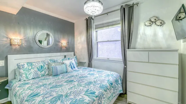 a bedroom with a bed and a chandelier