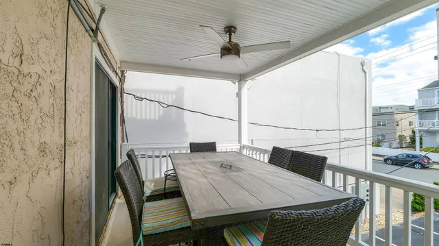 a view of balcony with wooden floor and outdoor seating