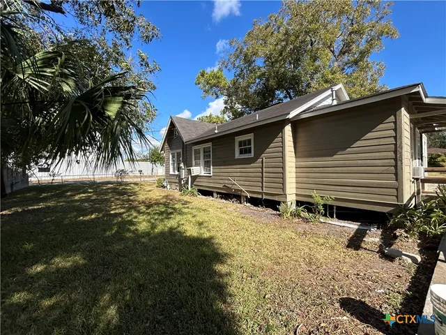a view of a hallway with wooden floor and stairs