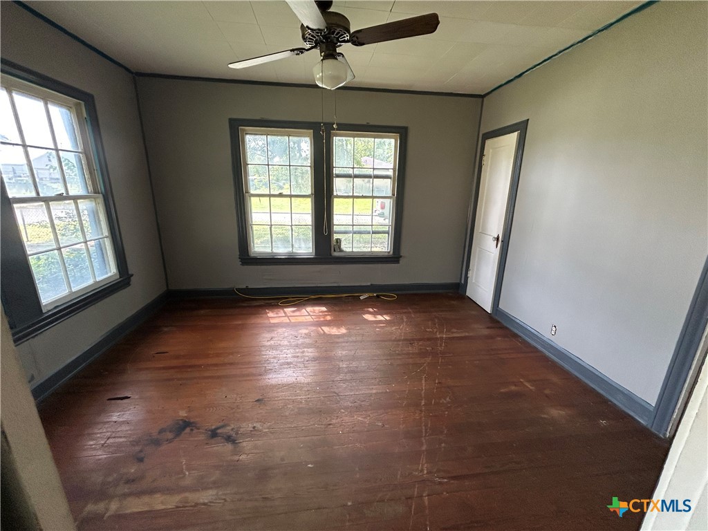 1511 East Constitution Street Victoria, TX 77901 - Photo 16 of 26 a view of empty room with wooden floor and fan