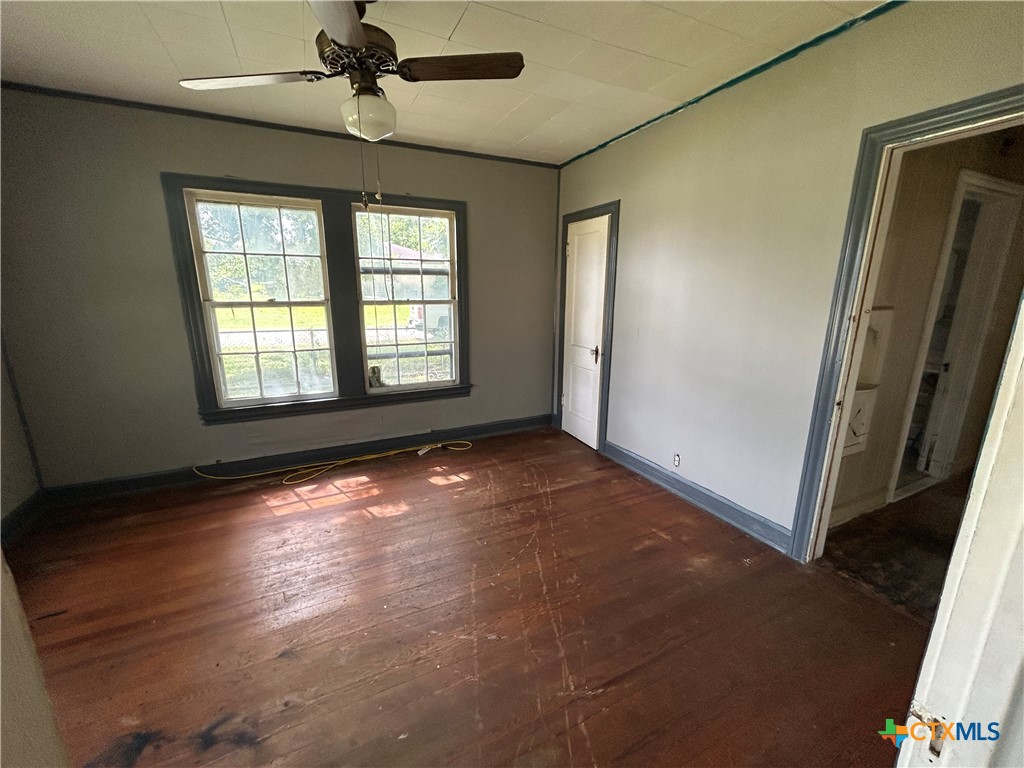 1511 East Constitution Street Victoria, TX 77901 - Photo 17 of 26 an empty room with wooden floor and windows