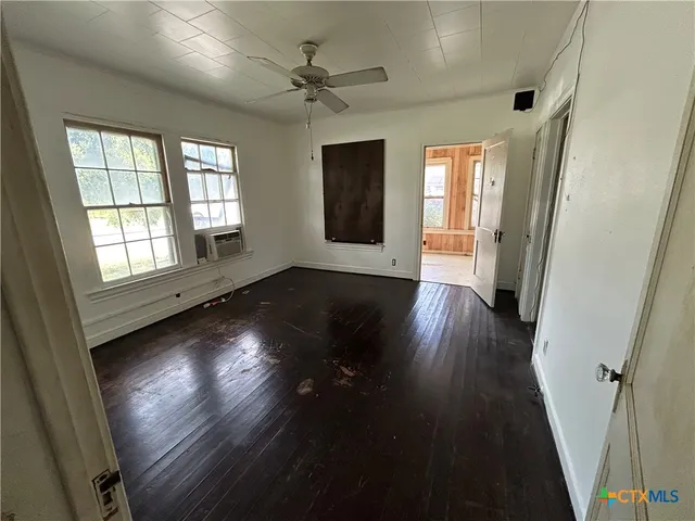wooden floor in an empty room with a window