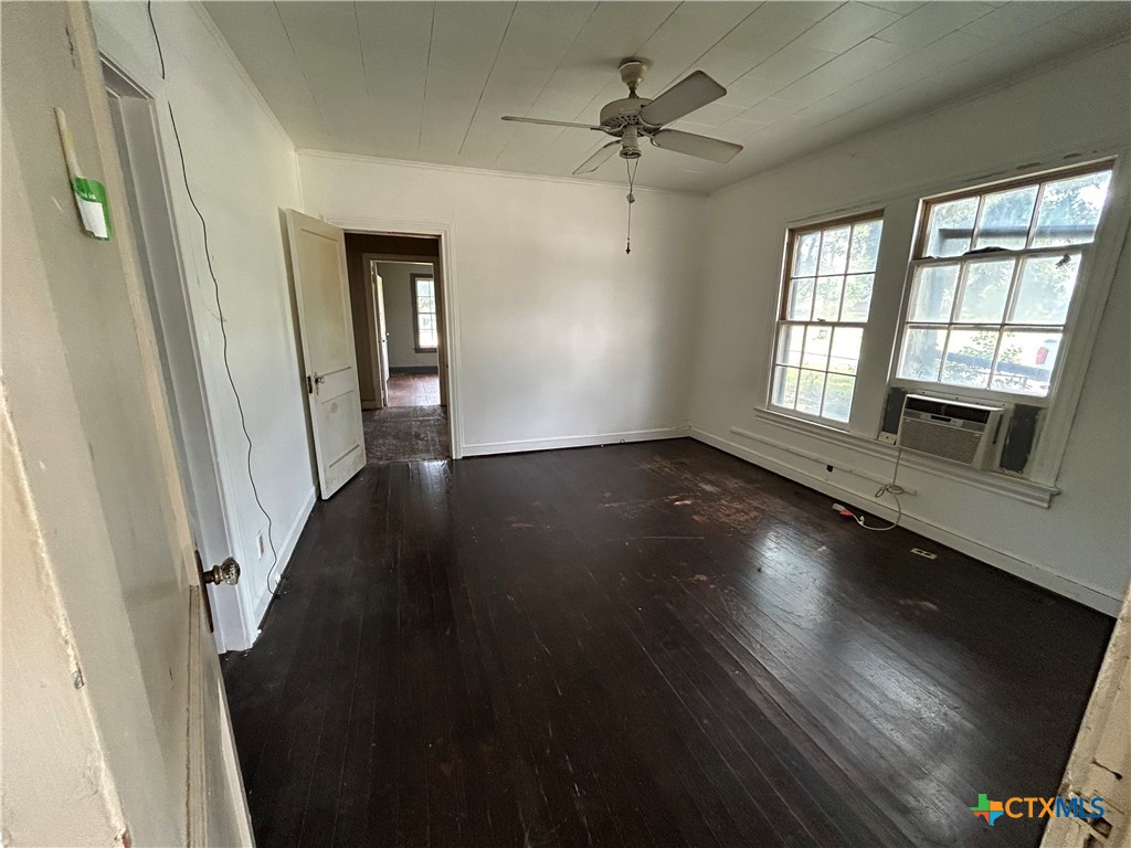 1511 East Constitution Street Victoria, TX 77901 - Photo 21 of 26 wooden floor in an empty room with a window