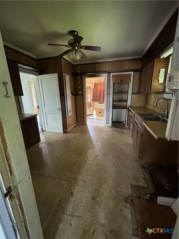 a kitchen with sink cabinets and window