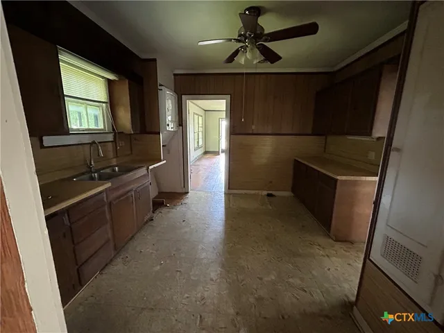 a view of an empty room with a fireplace and a window