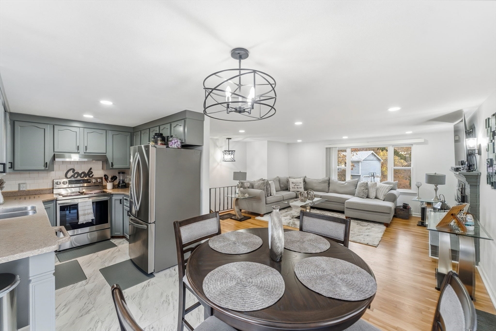 26 Wakefield Avenue Webster, MA 01570 - Photo 12 of 42 a living room with stainless steel appliances furniture dining table a rug and kitchen view