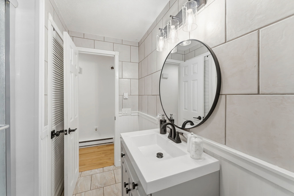 26 Wakefield Avenue Webster, MA 01570 - Photo 21 of 42 a bathroom with a sink a mirror and a shower