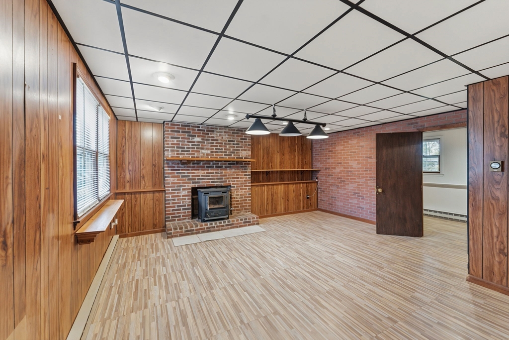 26 Wakefield Avenue Webster, MA 01570 - Photo 27 of 42 a view of empty room with wooden floor and fireplace