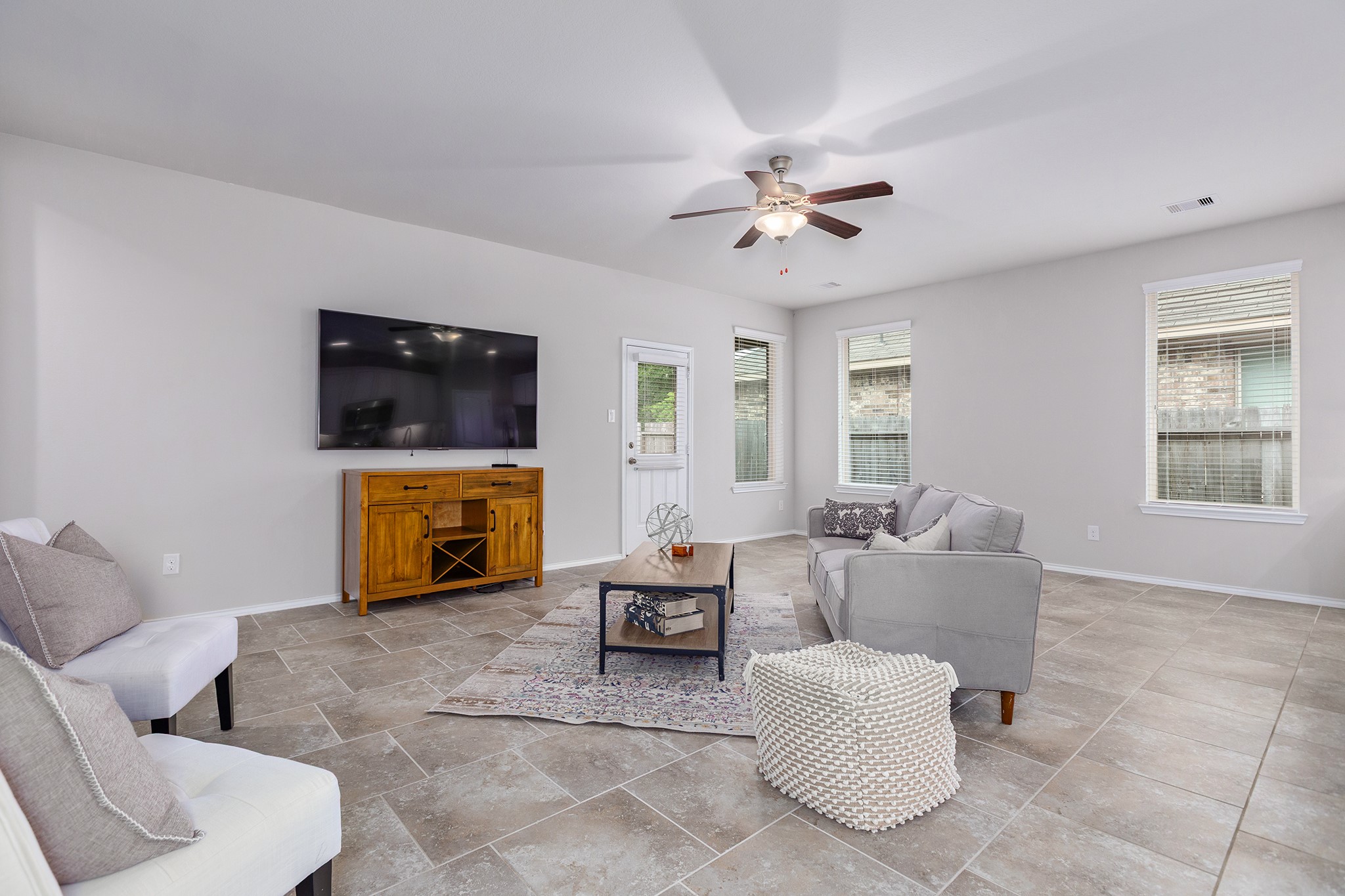 5611 Claymore Meadow Lane Spring, TX 77389 - Photo 10 of 32 a living room with furniture a fireplace and a flat screen tv
