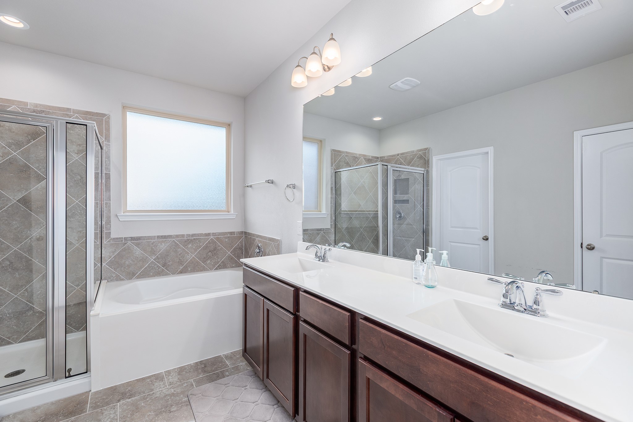 5611 Claymore Meadow Lane Spring, TX 77389 - Photo 16 of 32 a bathroom with a tub double sink mirror and
