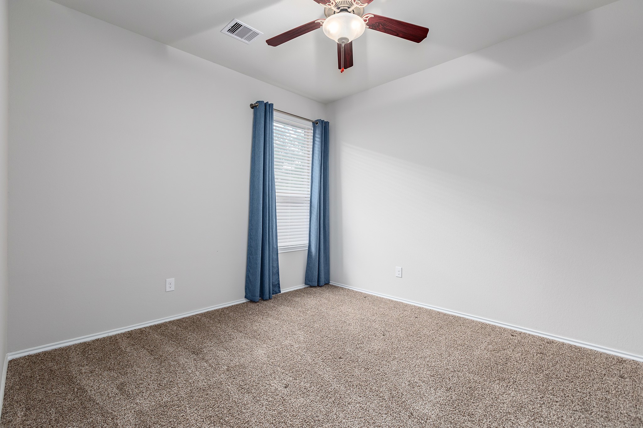 5611 Claymore Meadow Lane Spring, TX 77389 - Photo 25 of 32 an empty room with a chandelier fan and windows
